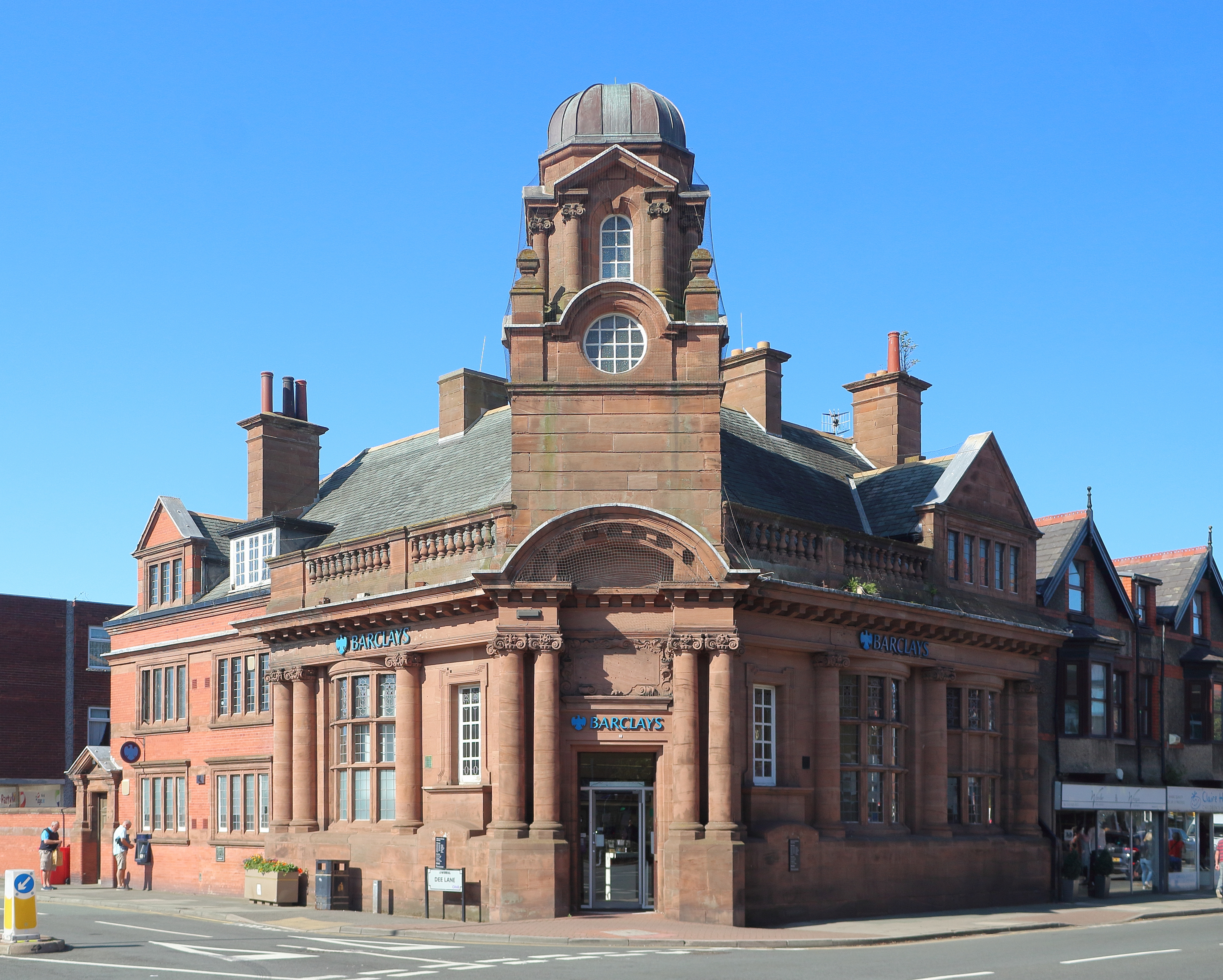 Photograph of a Barclays bank building in West Kirby, with blue Barclays signs above the entrance.